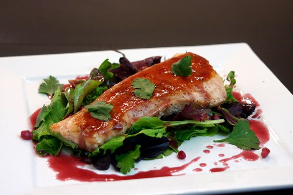 Pan Seared Salmon with Pomegranate Reduction served