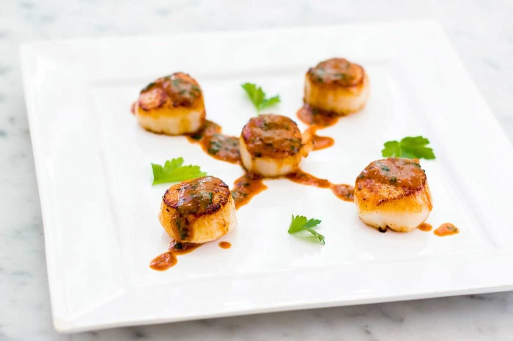 miso blood orange scallops served