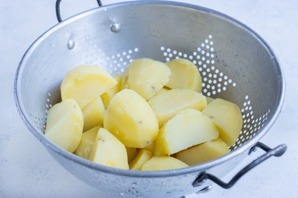 boiled potatoes in colander for freezing-kookybakes.com