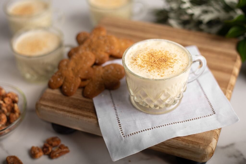 southern-comfort-spiced-eggnog-served-in-cup-with-cookies-kookybakes.com